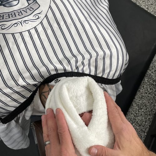 the man with hot towel on his face